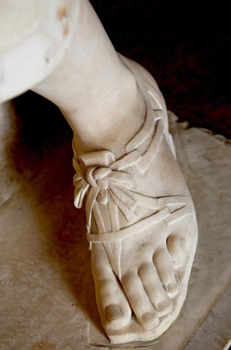Marble statue of a foot wearing a sandal